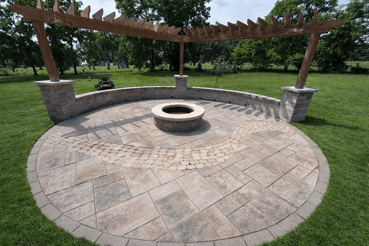 Paver patio with stone fire pit and cedar pergola outdoor living space in Wisconsin Dells, WI