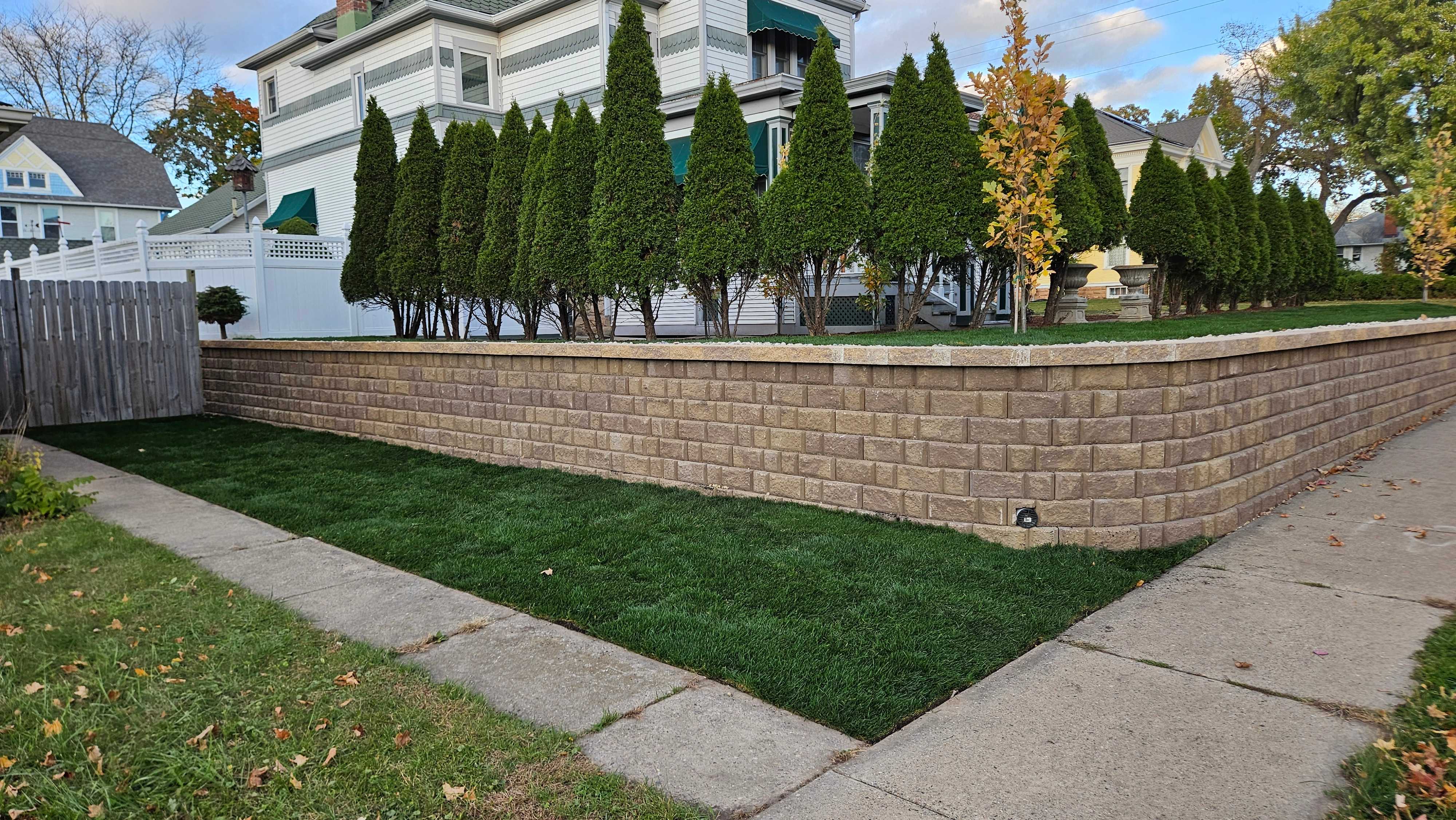 Residential Retaining Wall with Tree Plantings and Sod Lawn in Baraboo, WI