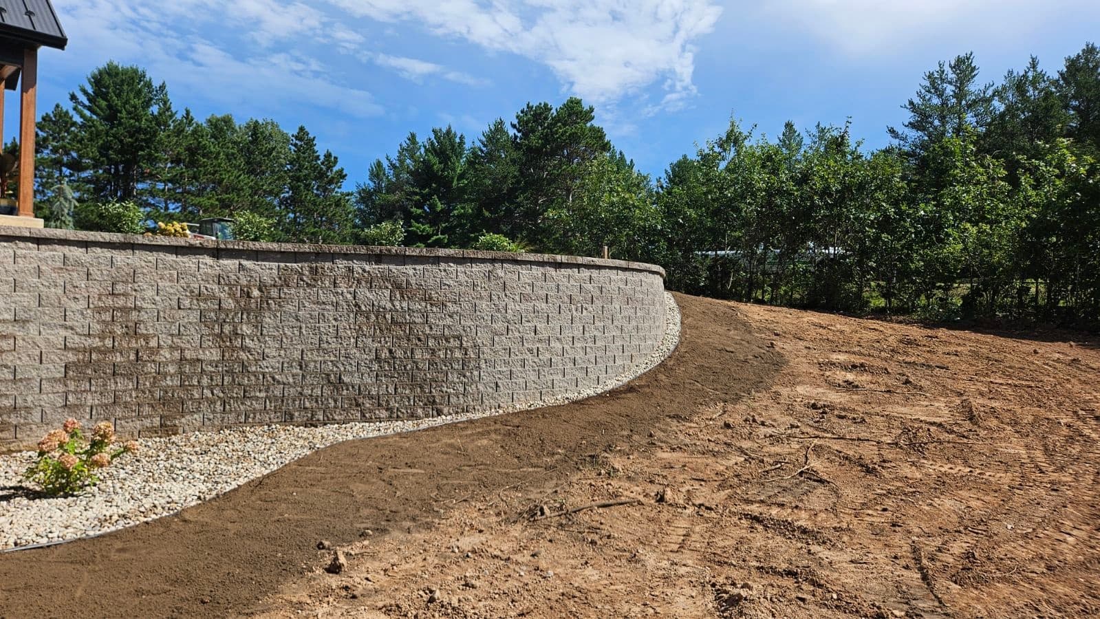 Large retaining wall with professional sod installation in rural Wisconsin