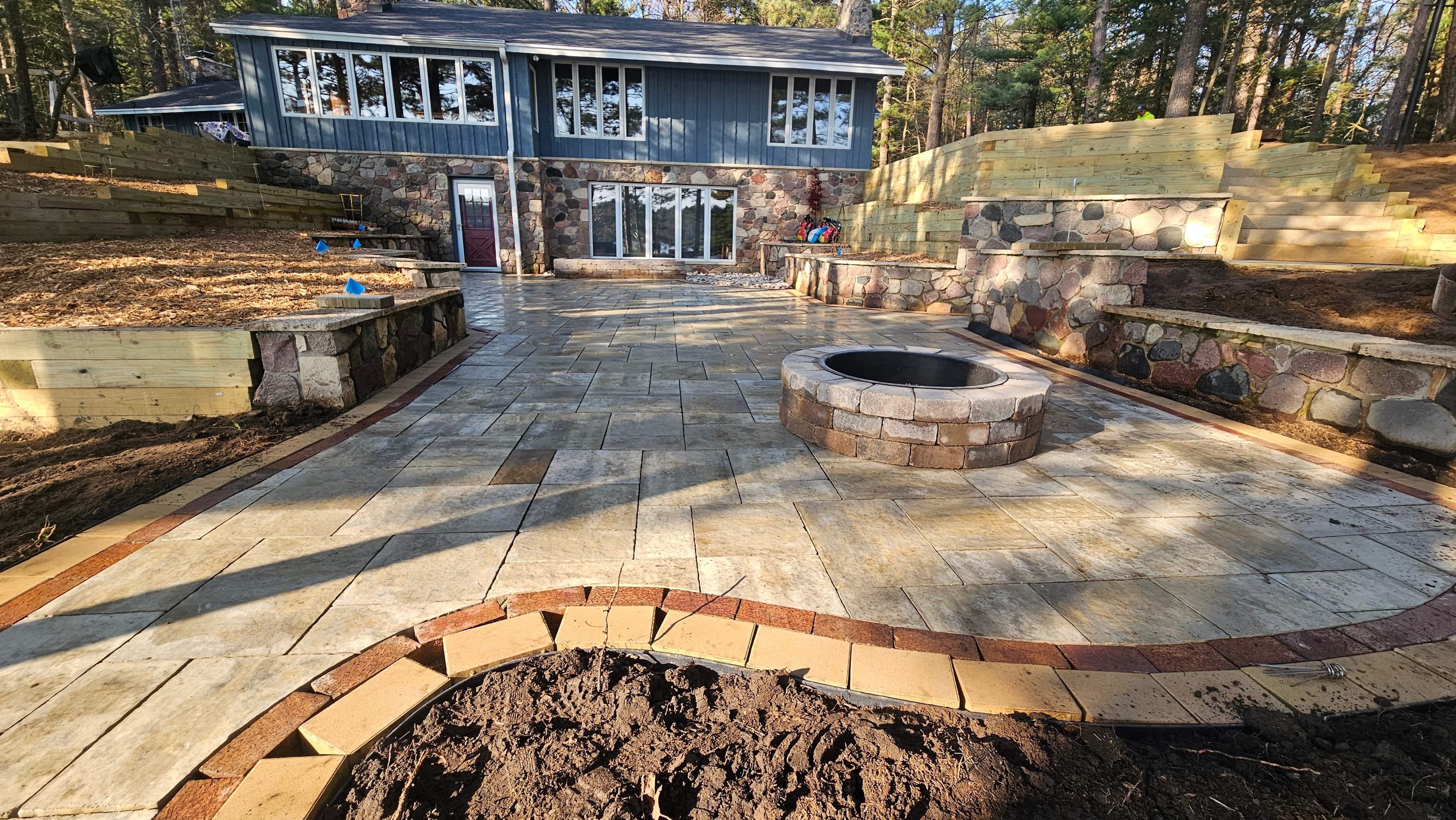 Professional patio and fire pit landscaping at a lakefront Wisconsin home