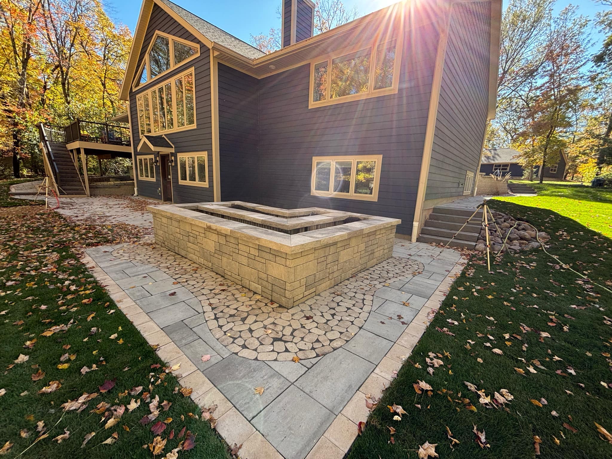 Raised natural stone planter box with paver patio hardscape installation in Wisconsin