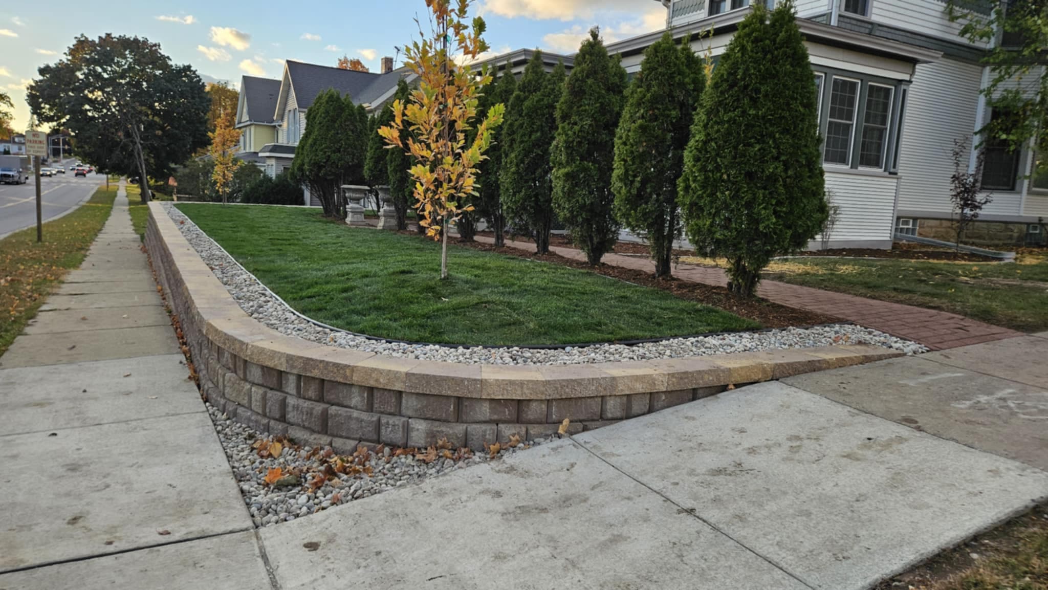Professional retaining wall with fresh sod lawn at historic Baraboo, WI home