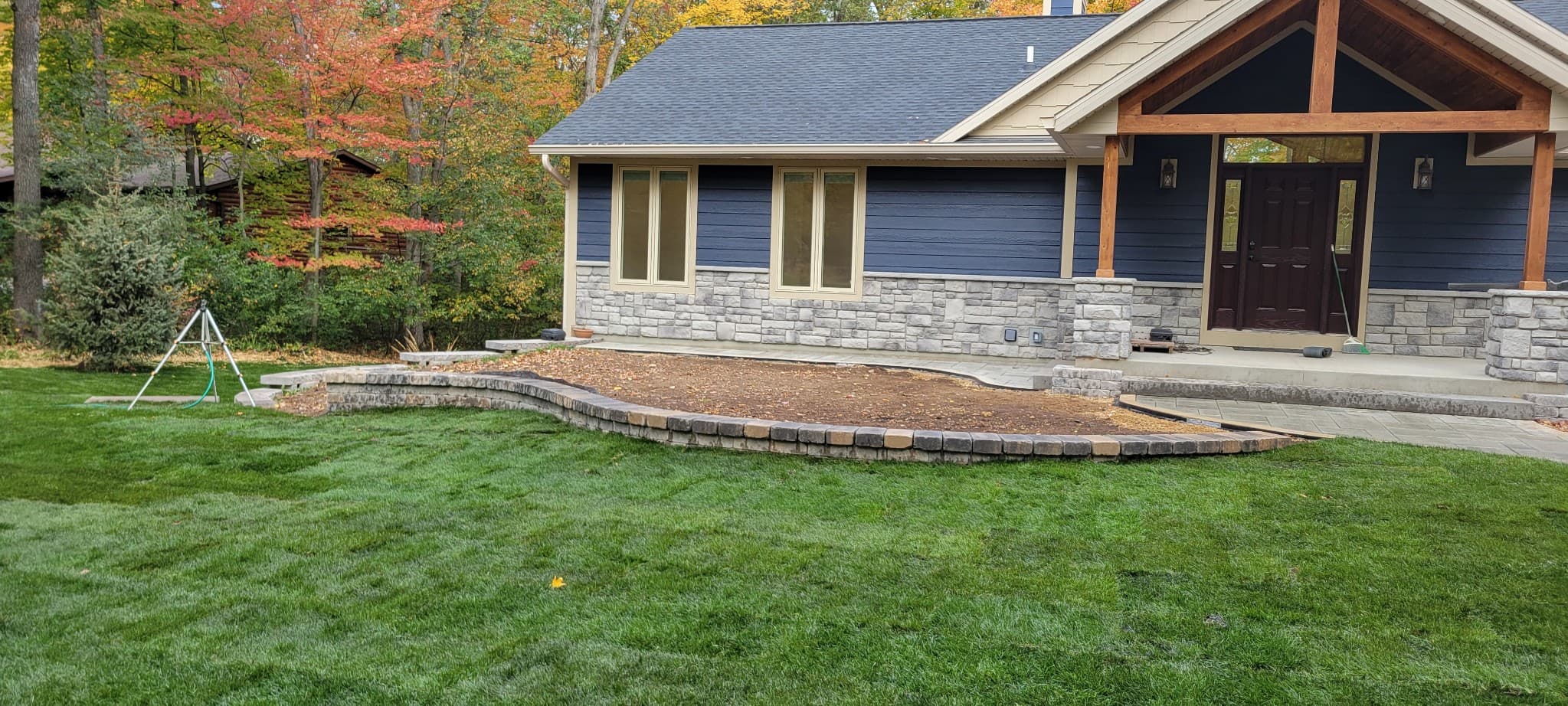 Large segmental block retaining wall with fresh sod lawn installation in Reedsburg, WI