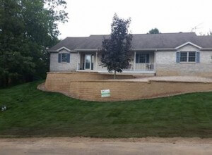 retaining wall, fire pit, walkway with crushed stone