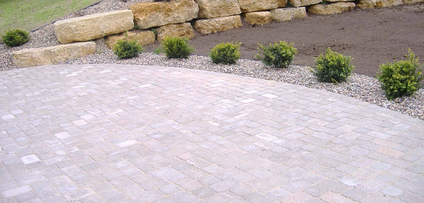 Patio, outdoor lighting, pillars, stone caps, fire pit, sod and plantings