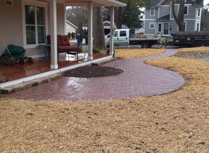 Patio, outdoor lighting, pillars, stone caps, fire pit, sod and plantings