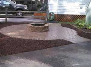 Patio, outdoor lighting, pillars, stone caps, fire pit, sod and plantings