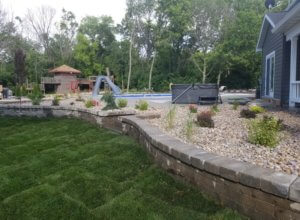 Sodding, retaining walls, plantings bushes, trees, edging