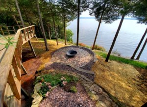 Patio, outdoor lighting, pillars, stone caps, fire pit, sod and plantings