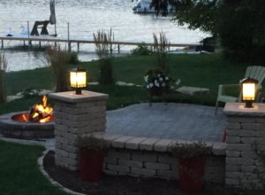 Patio, outdoor lighting, pillars, stone caps, fire pit, sod and plantings